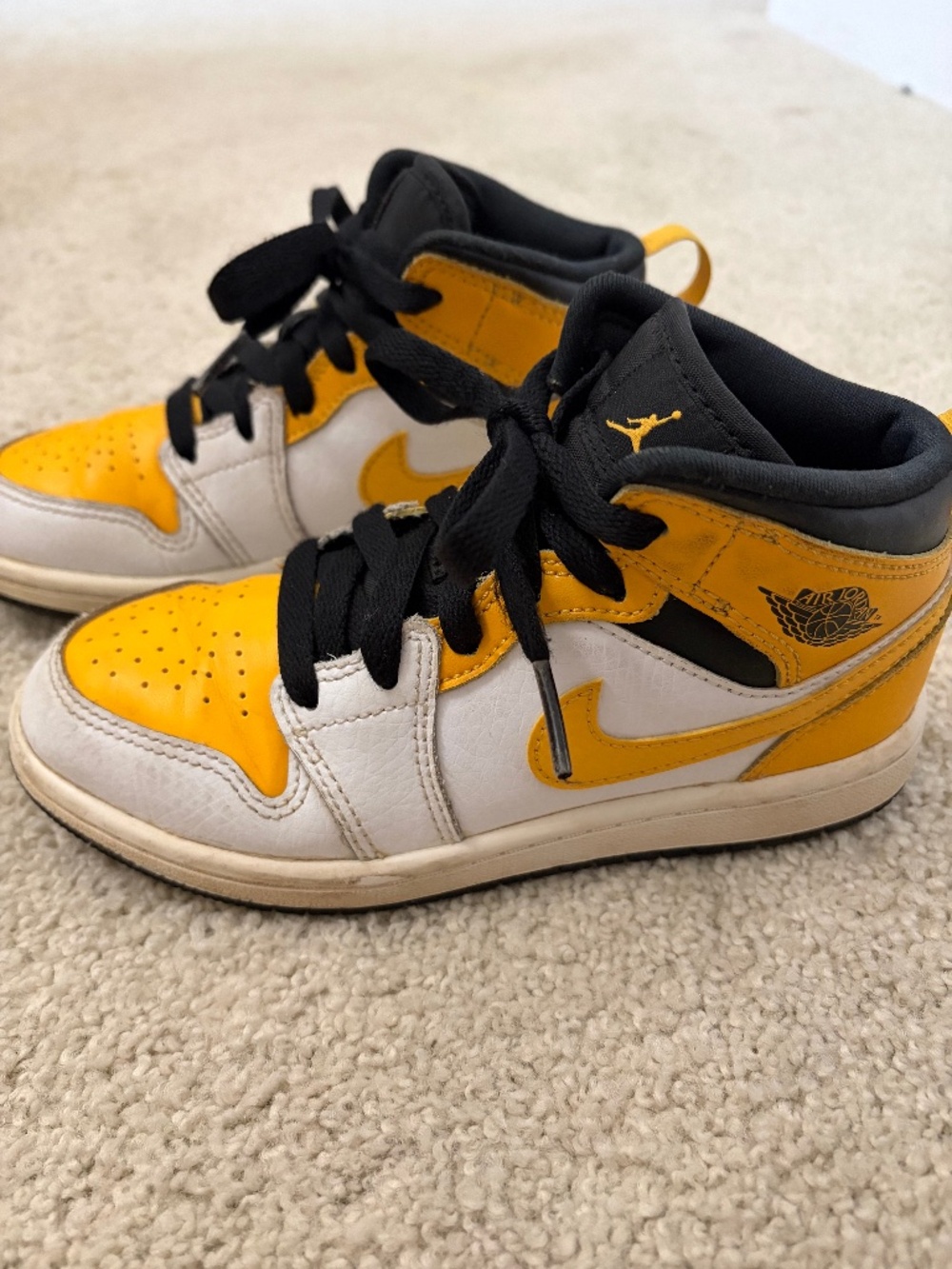 Kids black and yellow jordan sneakers